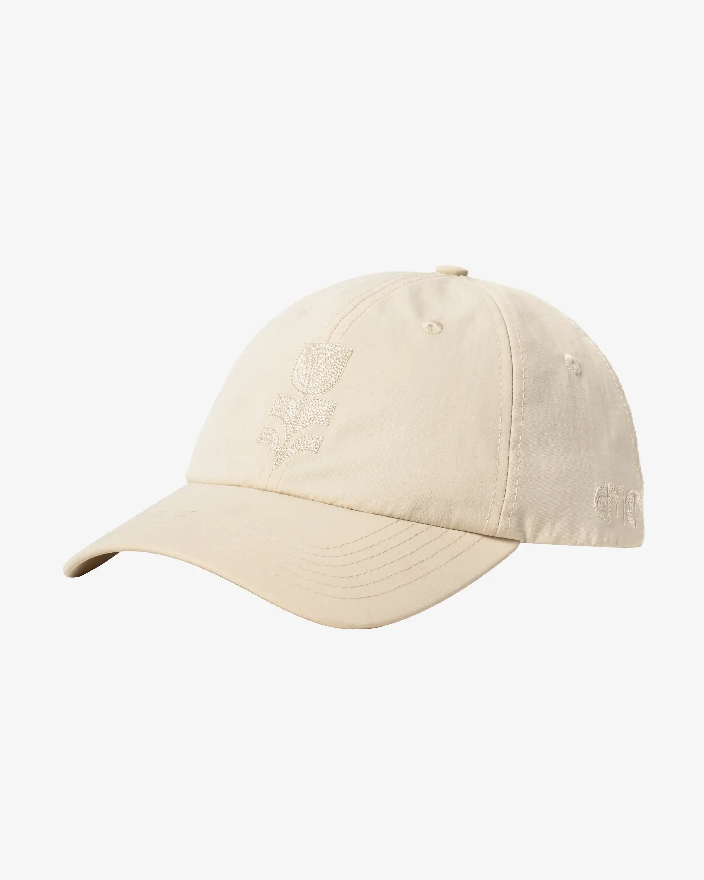 Six-panel cap featuring embroidered artwork from the Flourish collection.
Lightweight ripstop fabric with a soft, durable feel.
Classic curved-brim silhouette with an adjustable back strap for a customizable fit.
Tonal embroidered tulip graphic on the front and tonal Ementa logo embroidery on the side.
Off-white finish with matching tonal embroidery.
Made in Portugal.