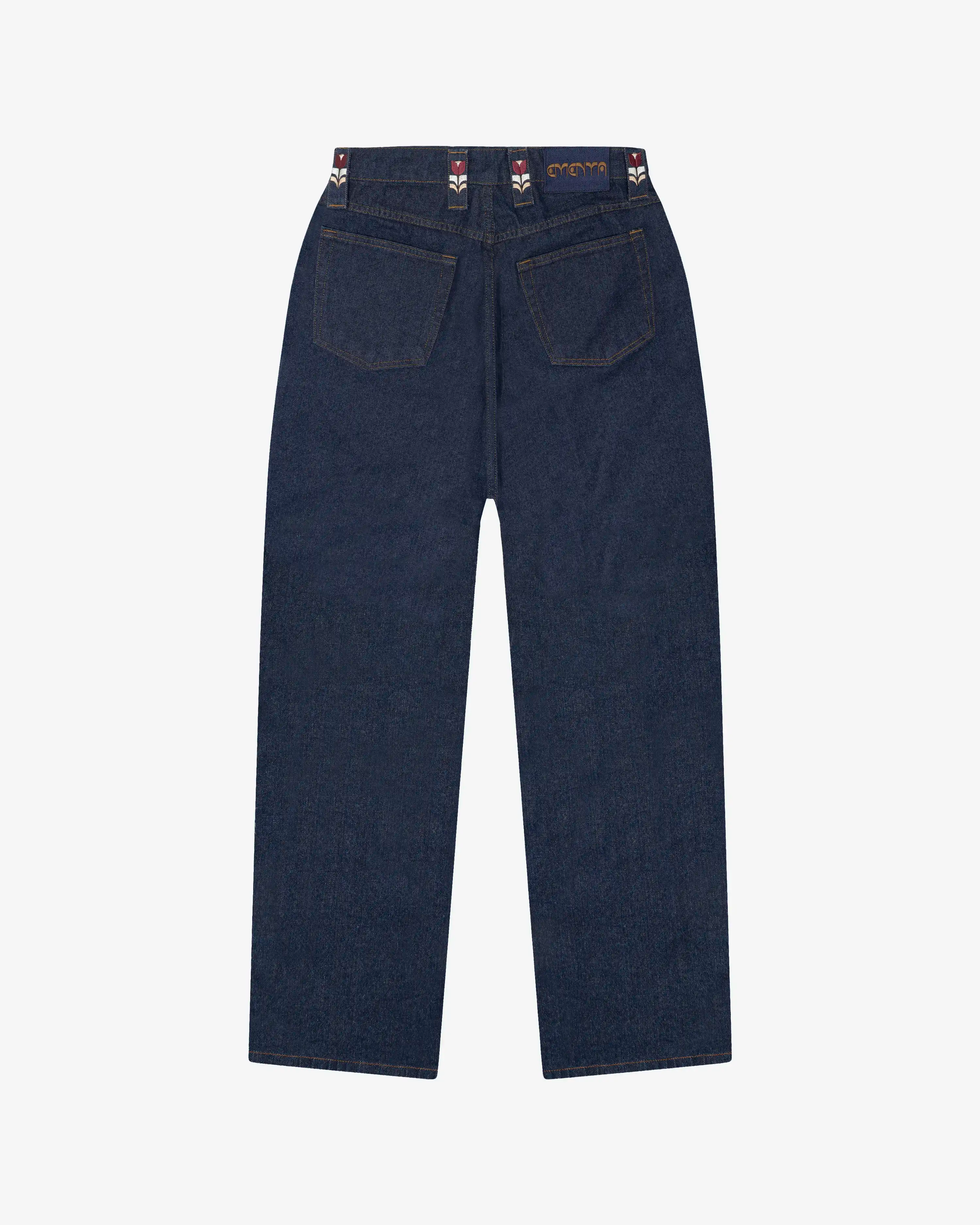 Straight-leg denim jeans designed for everyday wear as part of the Artist Edition Series, featuring artwork from the Flourish collection.
Raw blue denim construction with a structured feel that softens over time with wear.
Straight fit with a relaxed leg and classic five-pocket construction.
Features embroidered Flourish motifs on the belt loops, a matching embroidered coin pocket detail, and branded metal hardware with a zip fly.
Blue raw denim finish with contrast tobacco stitching and embroidered brandin