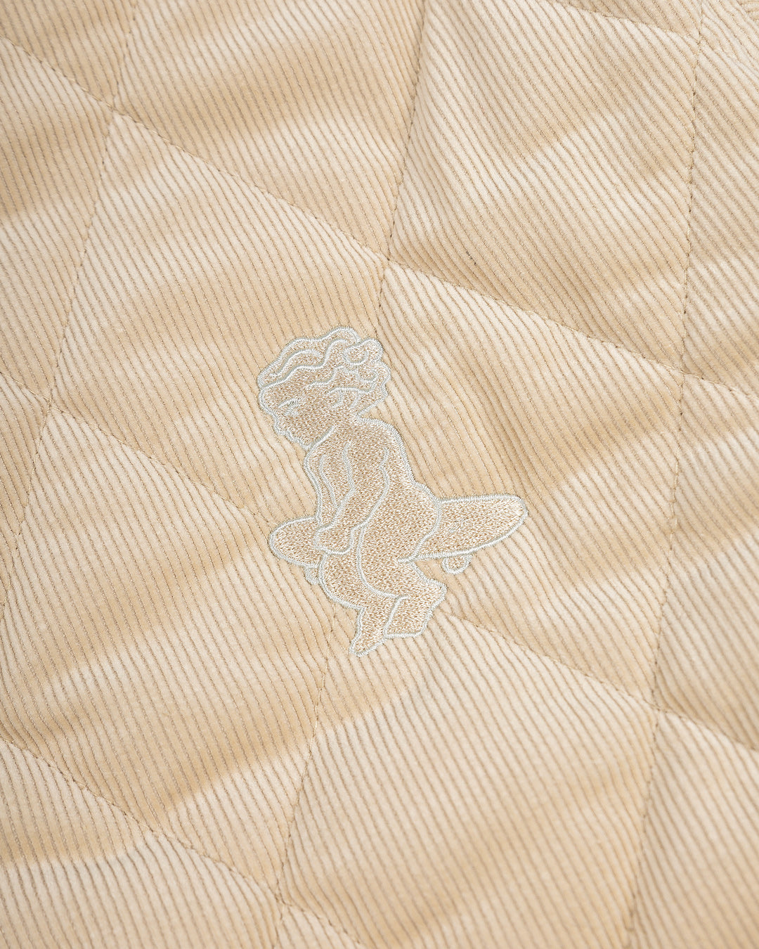 Classic style puffer jacket featuring diamond stitching for added texture. The exterior is crafted from soft corduroy, providing both comfort and durability, while the interior is made from smooth polyester for a cozy fit.