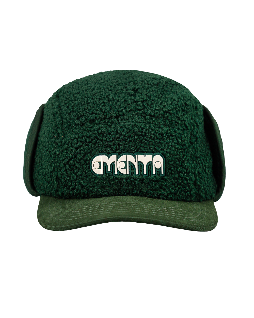 The Oreo Cap is a six-panel cap constructed with a sherpa outer shell for insulation and texture. It features ear flaps with a polar fleece lining on the inside for additional warmth and comfort. The flaps can be worn up or down, allowing for adjustable coverage. The cap has a curved brim that maintains its shape. The front panel displays the Dots Ementa logo.