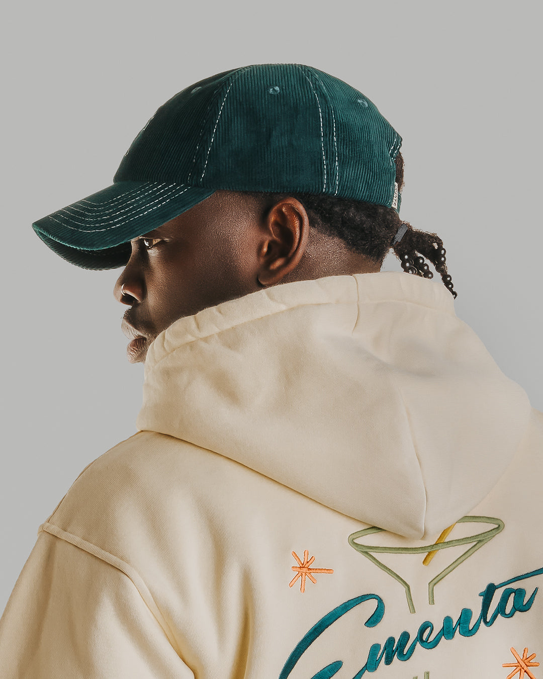 Forest green corduroy with white stitching running through the seams. The Liberation design is embroidered in white on the front, standing out against the soft texture. Six-panel build, curved brim, and an adjustable strap at the back. 100% cotton corduroy.