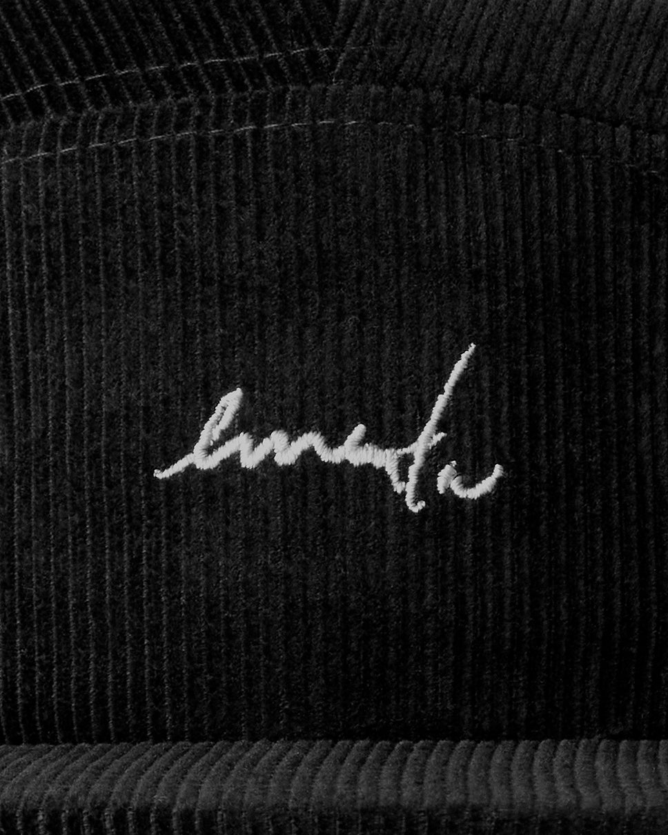 A five-panel cap crafted from cotton corduroy, offering a structured yet comfortable fit. Designed with a firm, flat brim and finished with our signature embroidery on the front. The adjustable strap with a plastic buckle allows for a customizable fit.