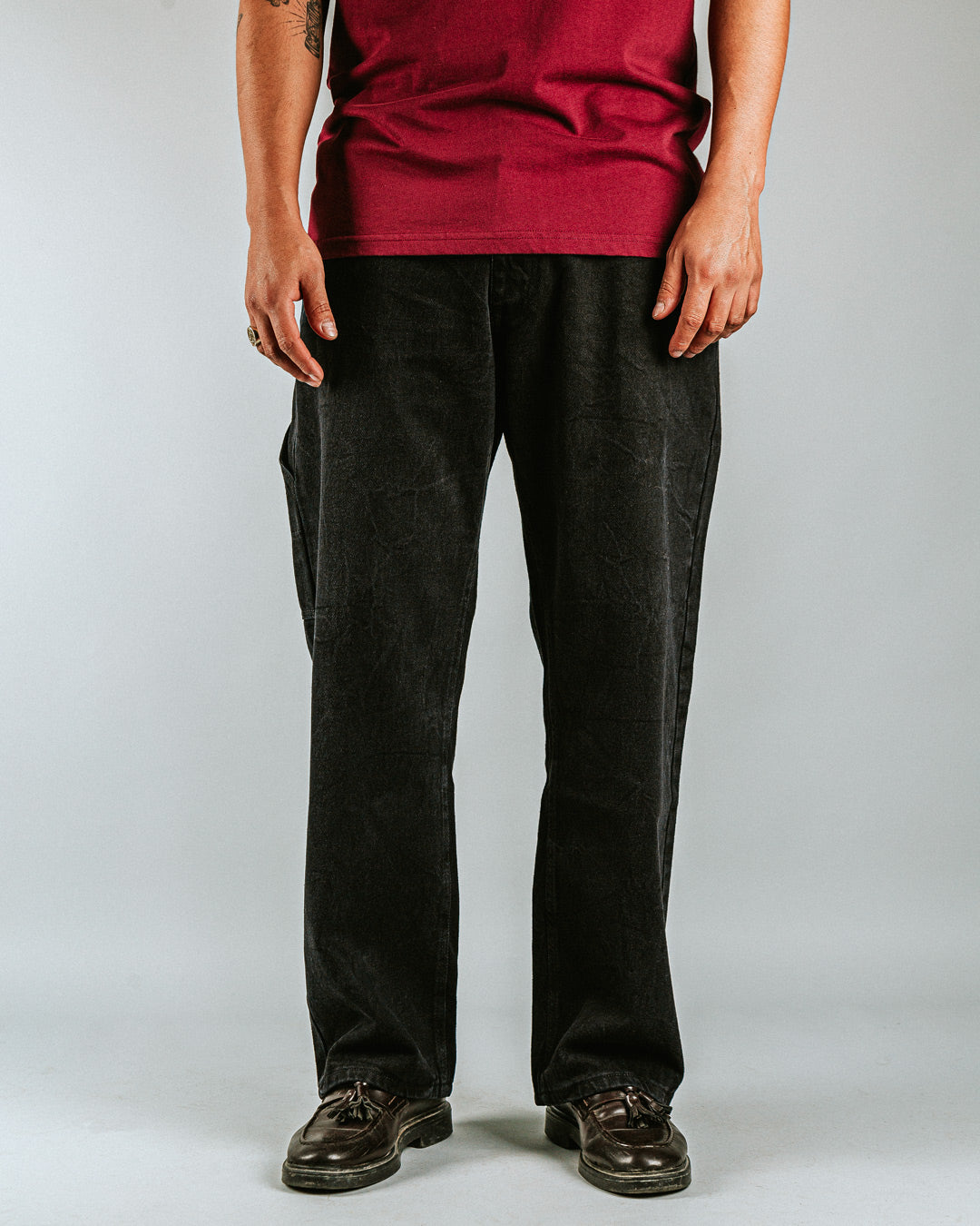 Relaxed-fit jeans made from black marble-washed denim, designed for comfort and durability with a focus on providing the perfect fit. The jeans feature the cocktail design embroidered on the back pocket for added detail. Equipped with two back pockets, two front pockets, and one side pocket for practical storage.