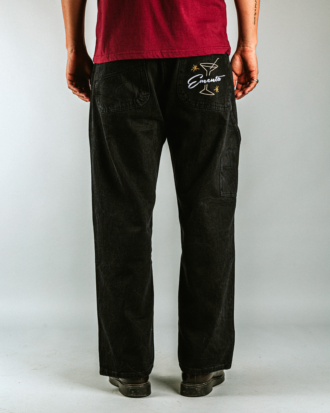 Relaxed-fit jeans made from black marble-washed denim, designed for comfort and durability with a focus on providing the perfect fit. The jeans feature the cocktail design embroidered on the back pocket for added detail. Equipped with two back pockets, two front pockets, and one side pocket for practical storage.