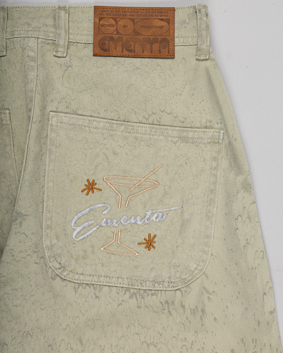 Relaxed-fit twill pants made from dyed green rag twill fabric, designed for comfort and durability with a focus on providing the perfect fit. The pants feature the cocktail design embroidered on the back pocket for added detail. Equipped with two back pockets and two front pockets.