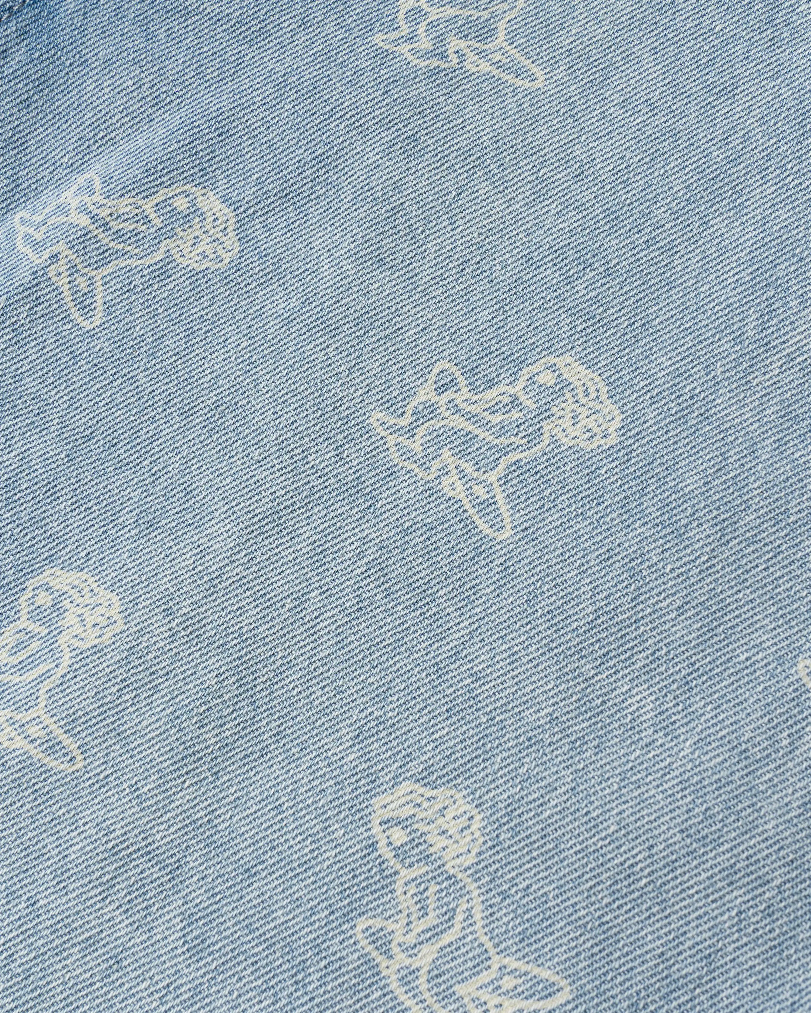 Light blue denim with all-over Ikon logo
Made from 100% cotton for a soft, breathable feel
Short-sleeved construction with a single chest pocket
Button front closure with tonal stitching
Slightly dropped shoulders for a relaxed silhouette
Unisex design
Cold wash only