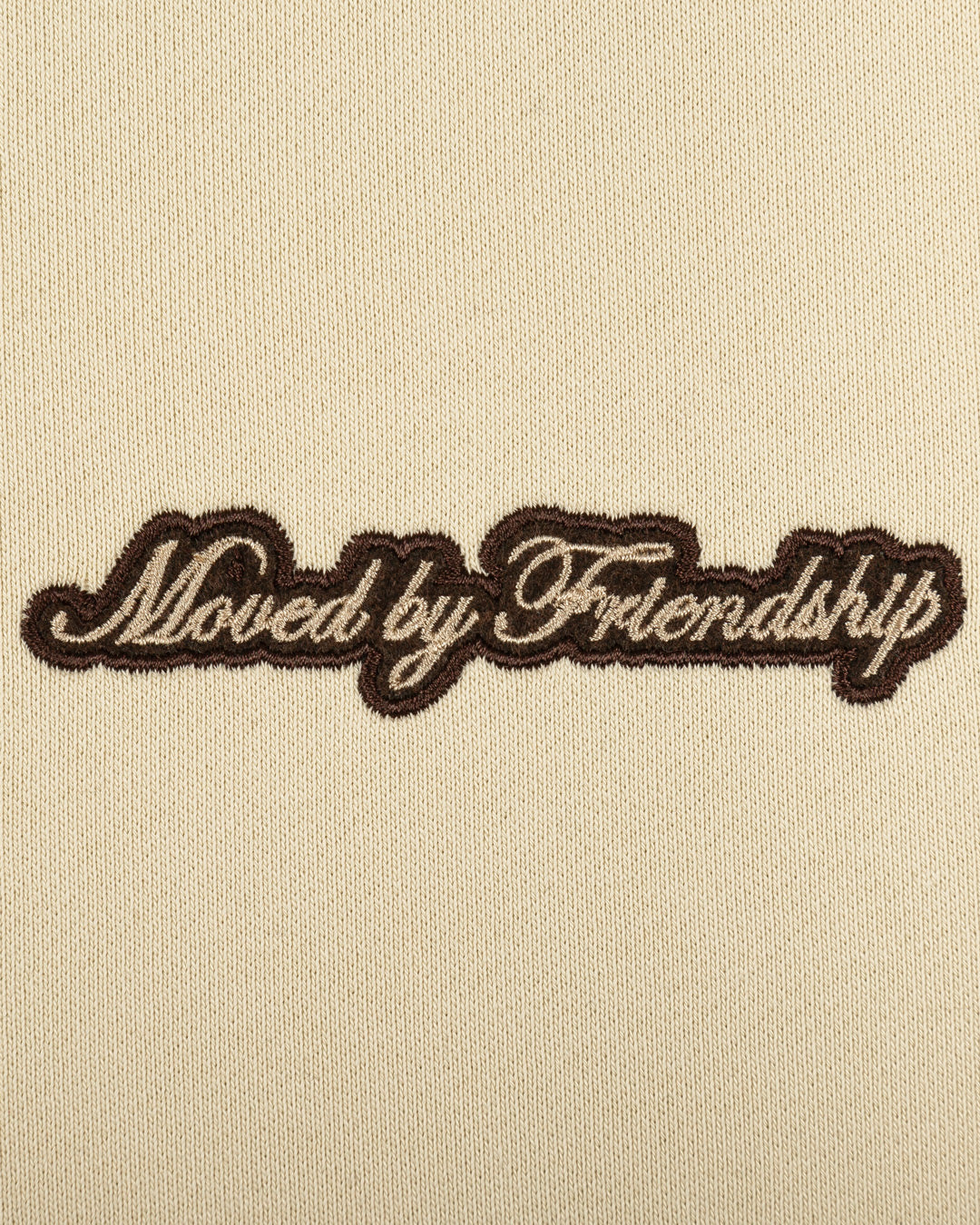 The Friendship Hoodie in off-white features the motto "Moved By Friendship" embroidered on the front in a classic handwritten style. On the back, the Ikon logo appears with a dragged effect, adding a distinctive detail.
Made from heavyweight 100% cotton, the hoodie is durable and warm, with a brushed fleece interior for extra comfort. Ribbed cuffs and hem provide structure, and the kangaroo pocket adds functionality.