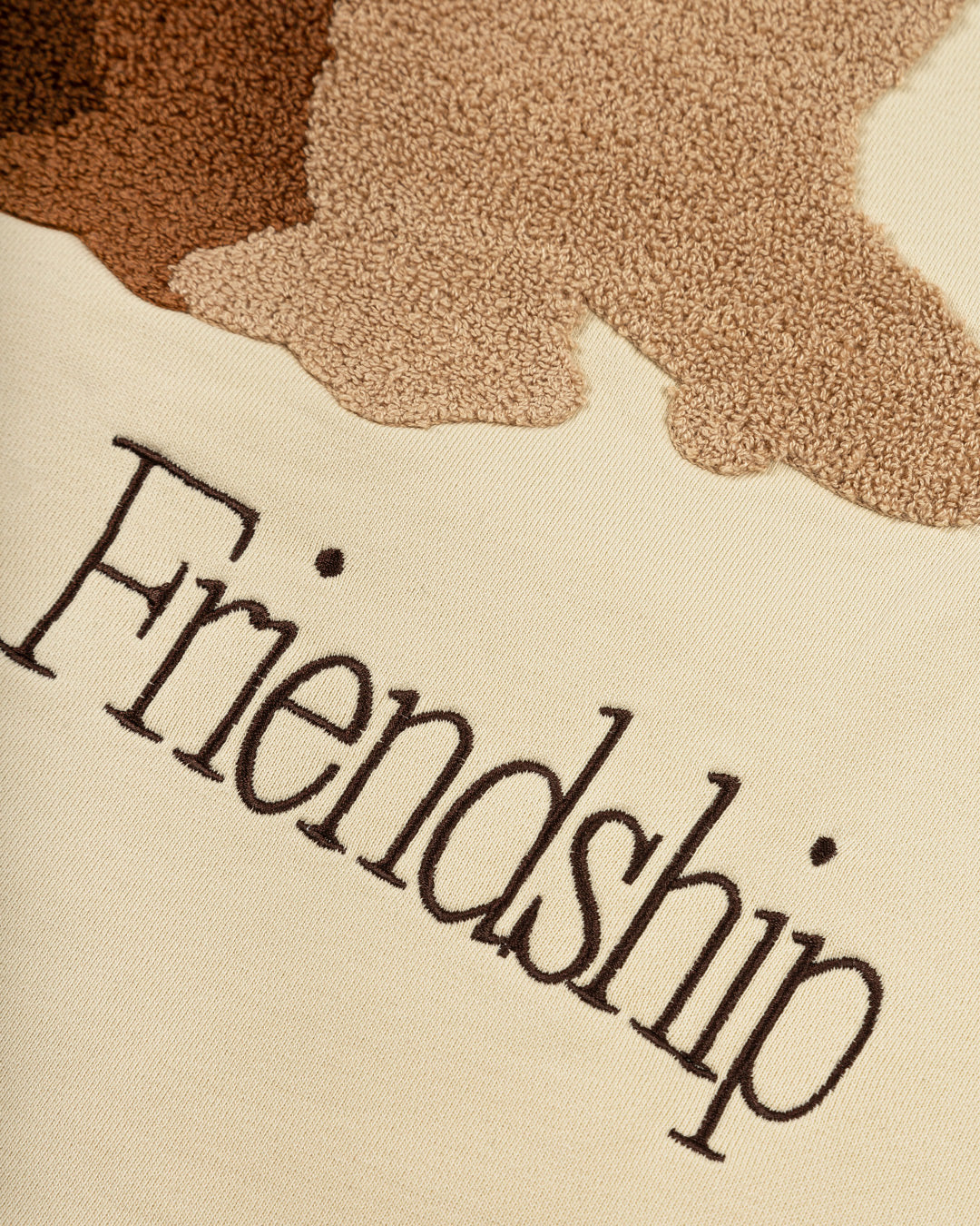 The Friendship Hoodie in off-white features the motto "Moved By Friendship" embroidered on the front in a classic handwritten style. On the back, the Ikon logo appears with a dragged effect, adding a distinctive detail.
Made from heavyweight 100% cotton, the hoodie is durable and warm, with a brushed fleece interior for extra comfort. Ribbed cuffs and hem provide structure, and the kangaroo pocket adds functionality.