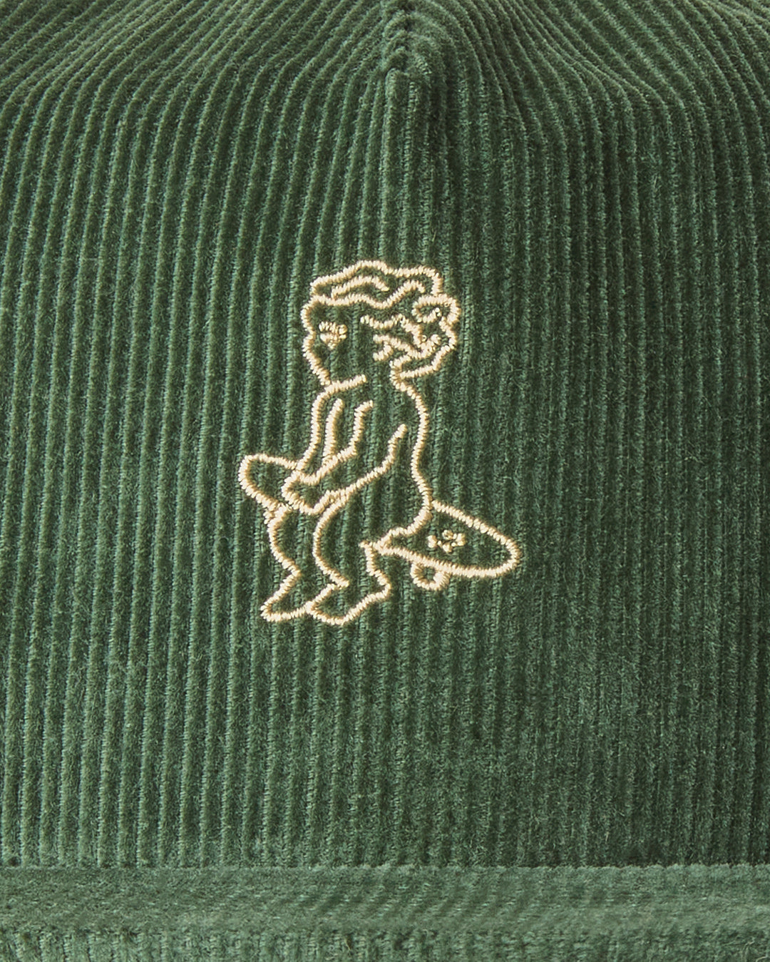 A flat five-panel cap in green, crafted from cotton corduroy for a structured yet comfortable fit. Designed with a rigid, flat brim and a lined front panel, it features top seams for added detail. The embroidered Ikon logo on the front adds a subtle touch, while the adjustable strap with a metal buckle ensures a customized fit.
