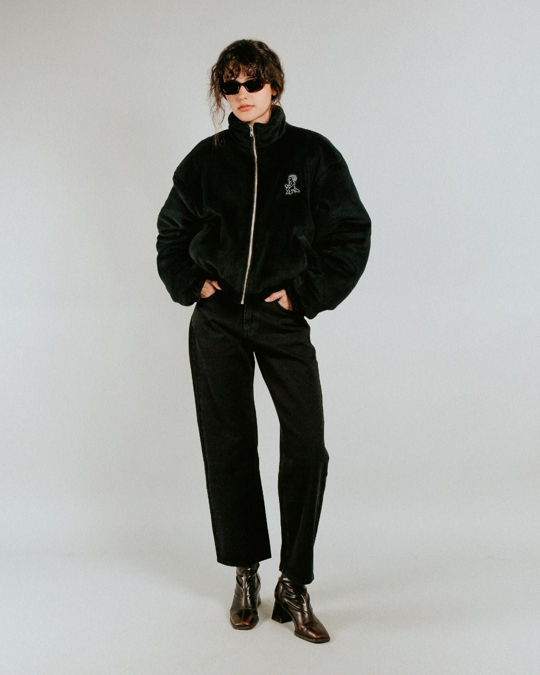The Ikon Fur Jacket features a soft black fur exterior and diamond stitching on the inside. The jacket also has the Ikon logo embroidered on the back, along with a corduroy interior for added detail.
It includes adjustable elasticated wrists and hips for a more tailored fit, along with two exterior pockets and one interior pocket for storage.