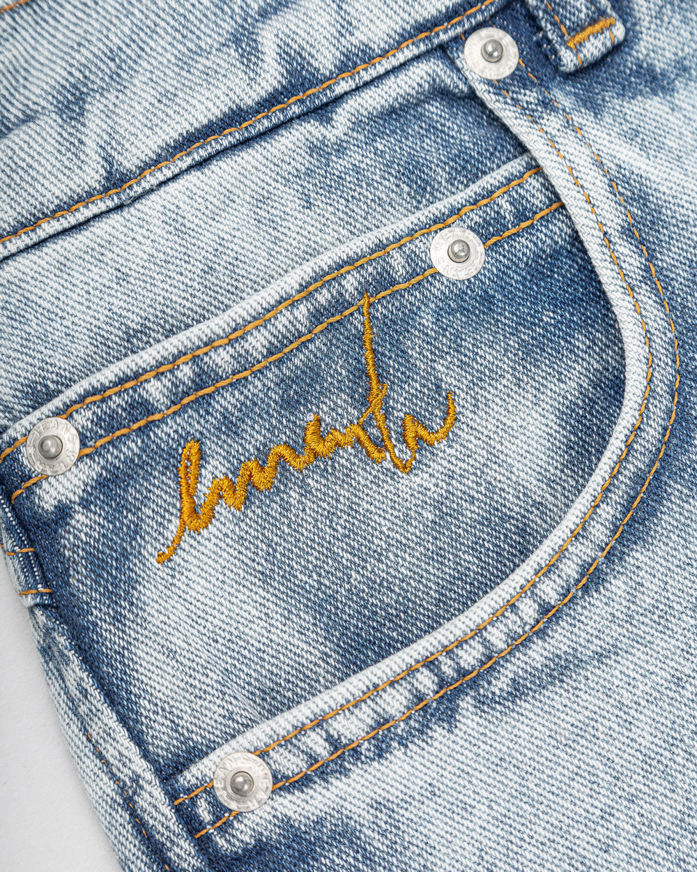 Relaxed-fit jeans made from blue fade-out, strong bleached denim, designed for comfort and durability. The jeans feature embroidered logos on the front and back, combining functionality with a clean, simple design.