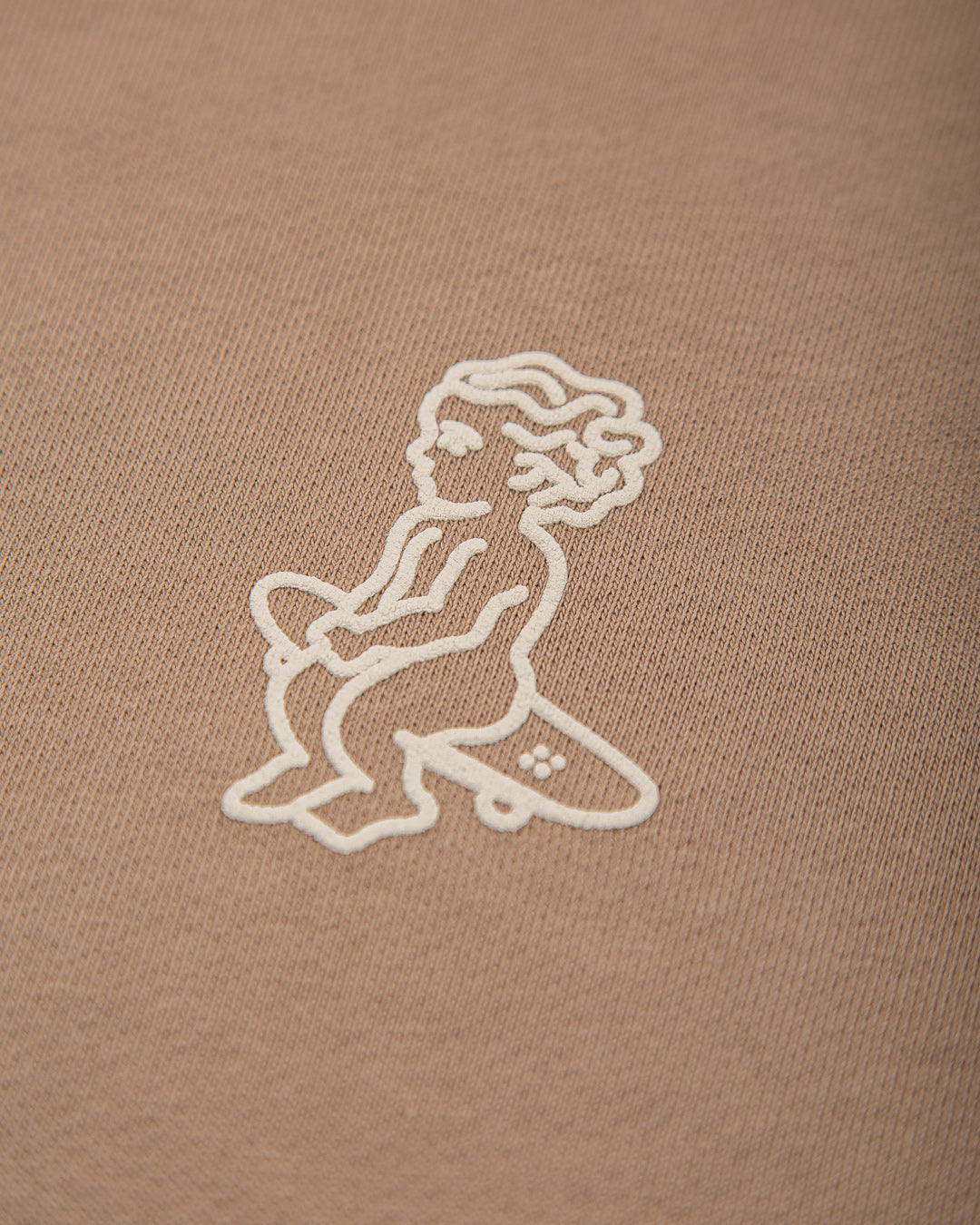 Crafted from heavyweight 100% cotton, this camel hoodie is designed to hold its shape and resist frequent wear, offering durability and a cozy feel. The interior is lined with heavyweight brushed fleece for added warmth. It features an embossed print with a textured Ikon stamp and an embroidered signature on the right wrist.