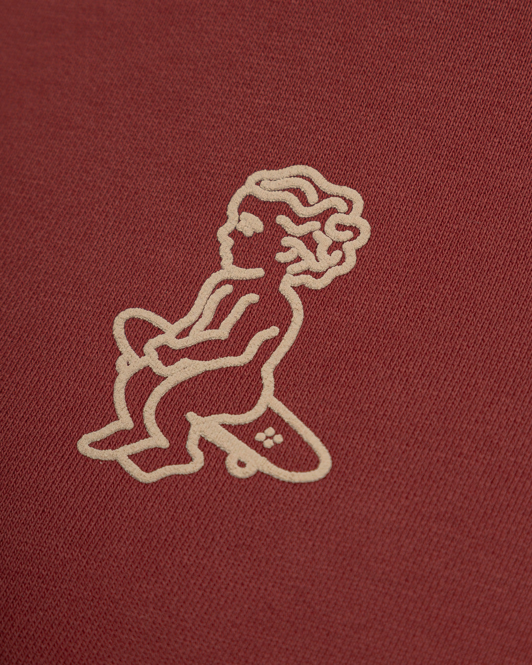 This burgundy hoodie is made of heavyweight fabric, designed to hold its shape and resist frequent wear. It is designed to ensure durability and warmth. Our artists digitally designed the print.