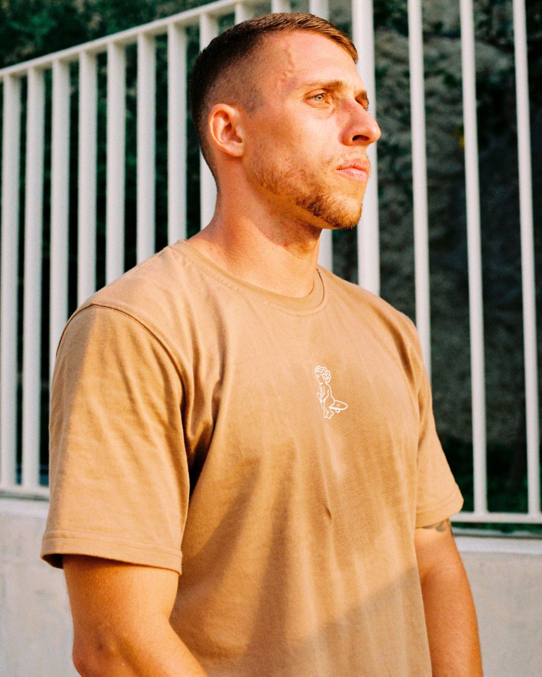 Made from 100% soft cotton, this camel-colored t-shirt is designed to maintain its shape over time. The Ikon stamp design in white is digitally created by our artist team for a unique touch.