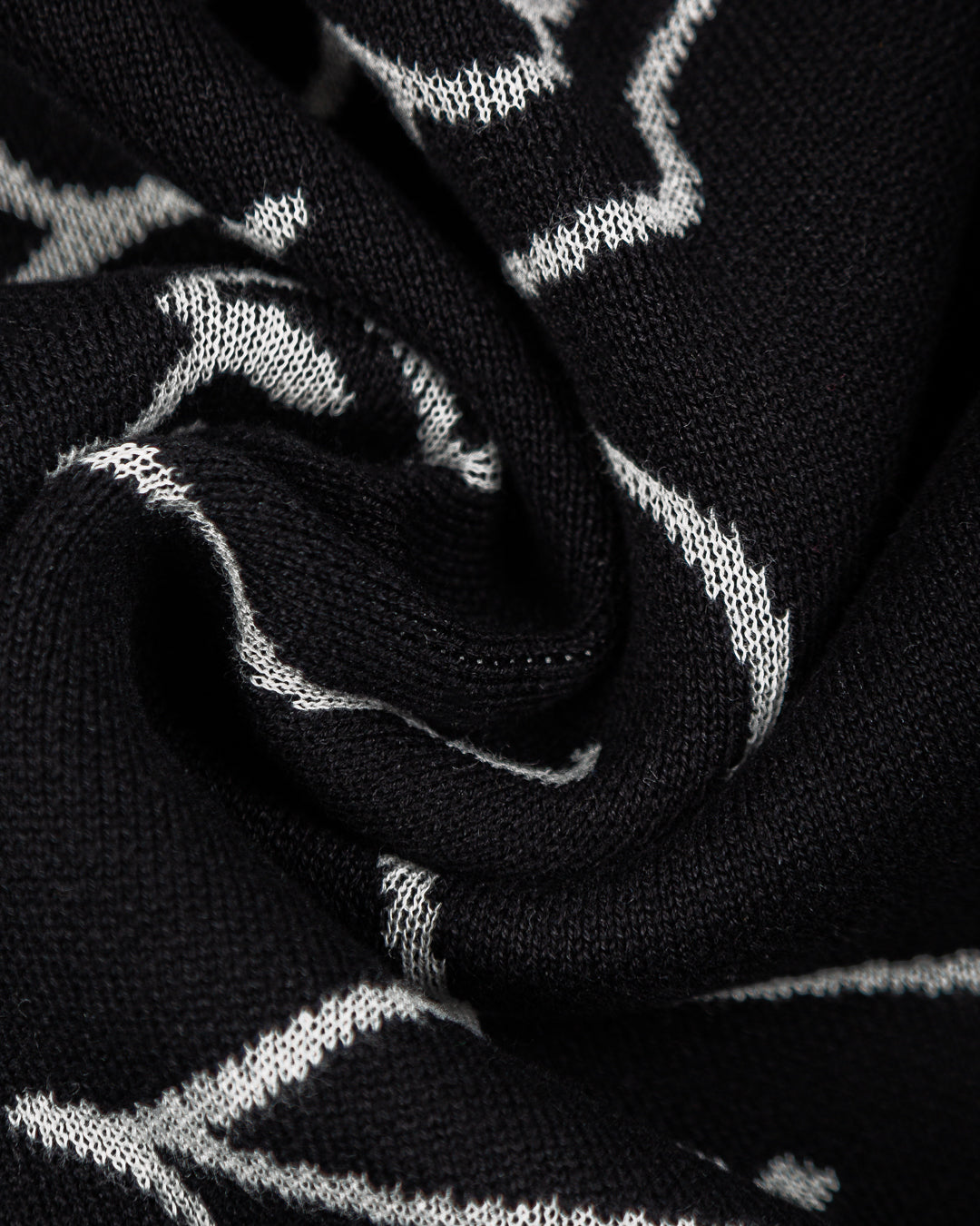 Knit cardigan made from soft yarn, featuring a classic cardigan design that blends modern elements with timeless style. The piece showcases a bold Ikon World design on the back and an Ementa logo embroidered on the chest.