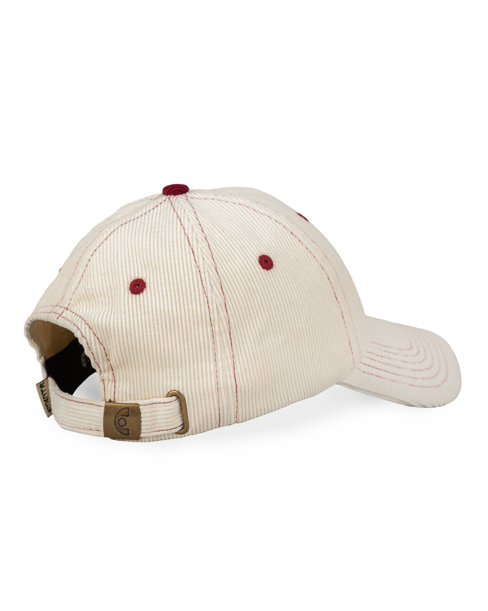 Off-white corduroy with burgundy stitching running through the seams. The Liberation design is embroidered in deep burgundy on the front, standing out against the soft texture. Six-panel build, curved brim, and an adjustable strap at the back. 100% cotton corduroy.