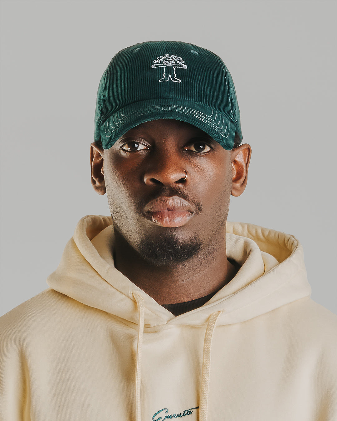 Forest green corduroy with white stitching running through the seams. The Liberation design is embroidered in white on the front, standing out against the soft texture. Six-panel build, curved brim, and an adjustable strap at the back. 100% cotton corduroy.