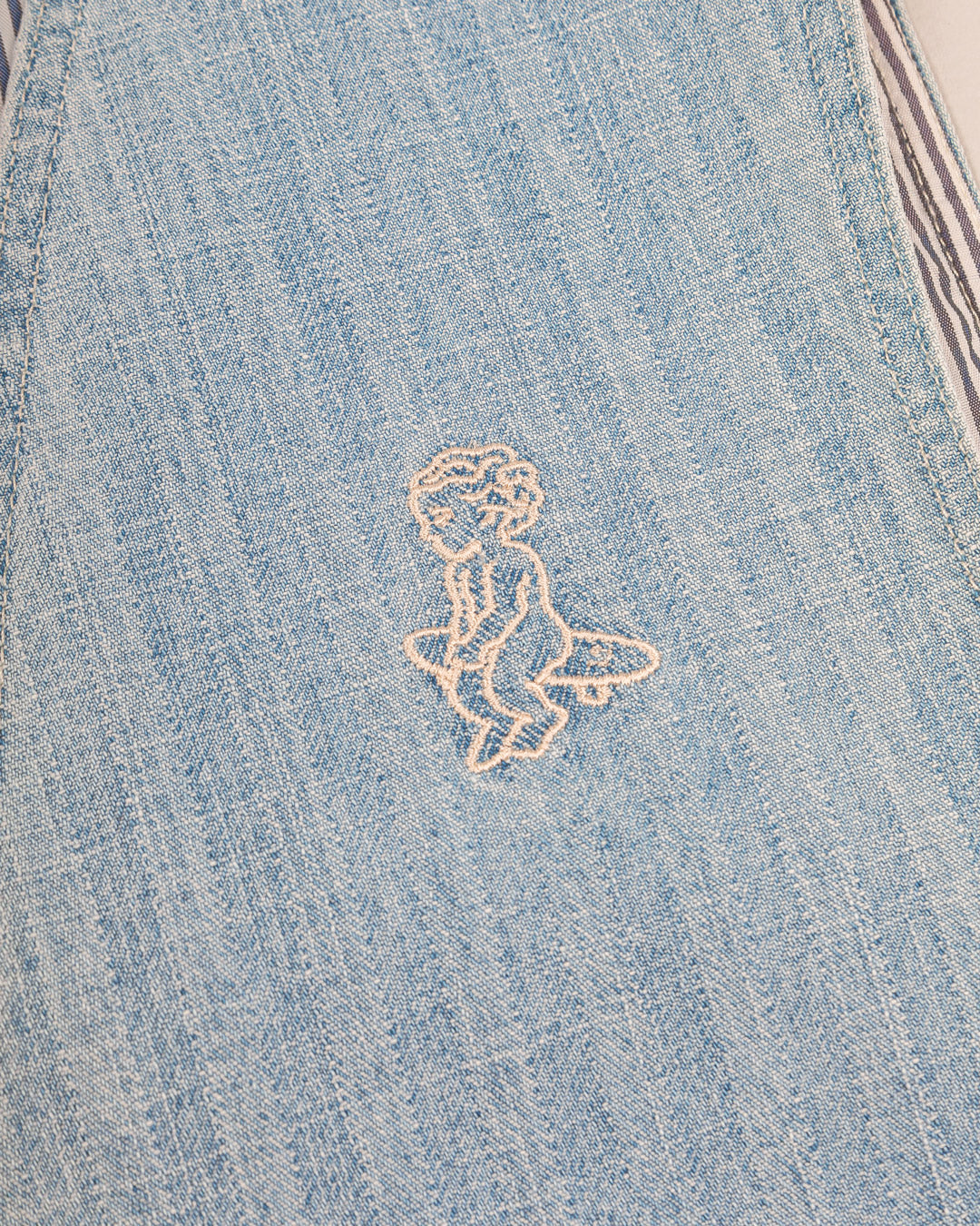 Denim striped vest made from soft, durable cotton fabric. The design features a striped denim pattern with an embroidered Ikon logo on the chest, combining texture and subtle branding.