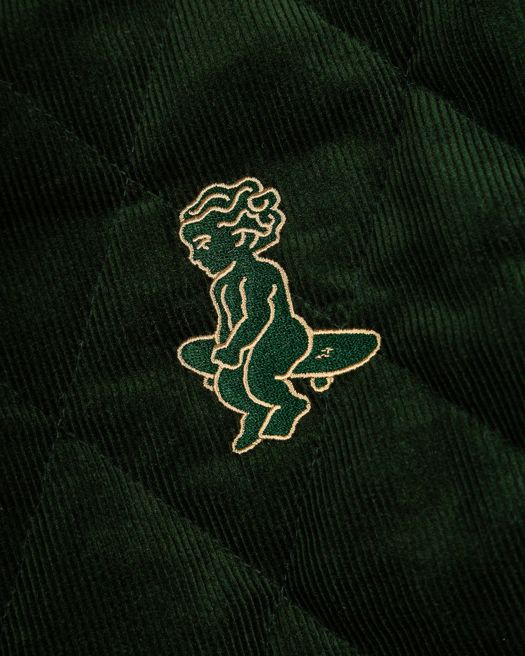 Classic style corduroy puffer jacket in green featuring diamond stitching for added texture. The exterior is crafted from soft corduroy, providing both comfort and durability, while the interior is made from smooth polyester for a cozy fit.