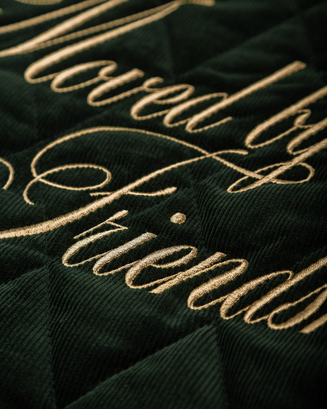 Classic style corduroy puffer jacket in green featuring diamond stitching for added texture. The exterior is crafted from soft corduroy, providing both comfort and durability, while the interior is made from smooth polyester for a cozy fit.