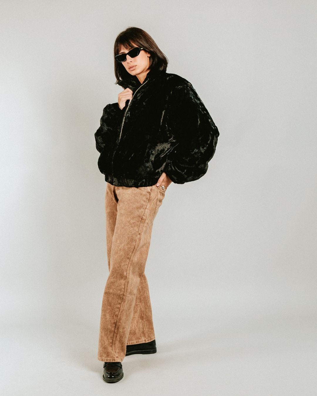 The Milaya Black Fur Jacket is designed for warmth and comfort, featuring a soft black fur exterior. Inside, it has diamond stitching for added texture and durability.