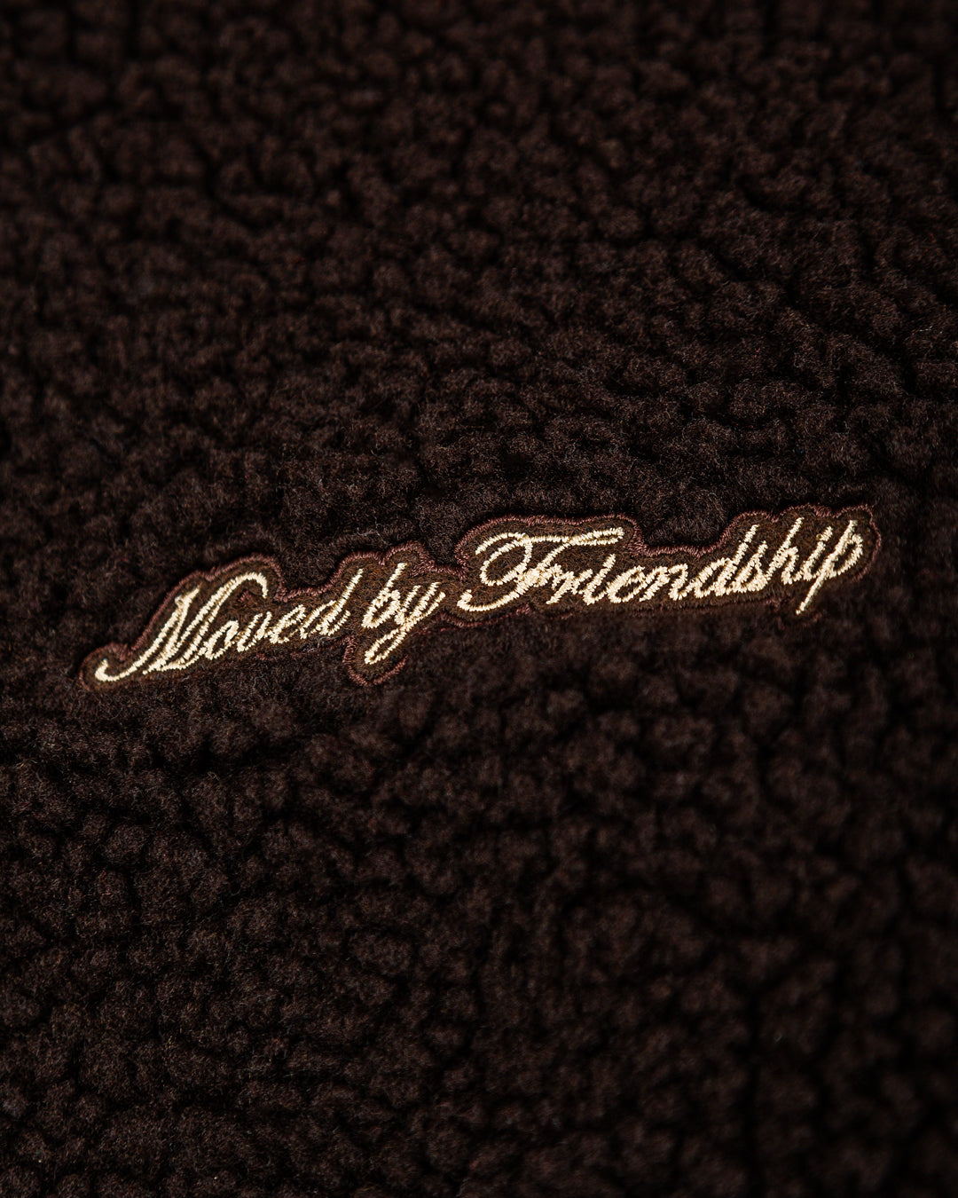 The Oreo Friendship Polar Jacket combines warmth and comfort with its thick brown polar exterior. Inside, puffed diamond stitching adds texture and durability, enhancing its cozy feel.
Elasticated wrists and hips provide a customizable fit, while two exterior pockets and one interior pocket offer convenient storage. The chest features the motto "Moved by Friendship" embroidered, and the back showcases the dragged effect Ikon logo.