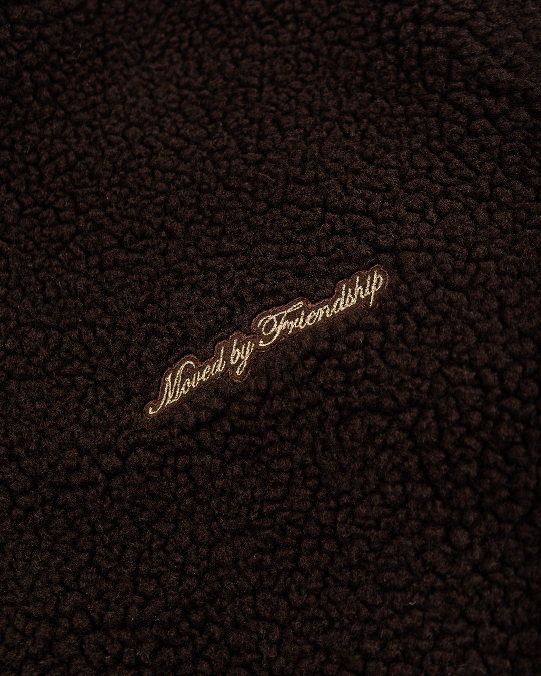 The Oreo Friendship Polar Jacket combines warmth and comfort with its thick brown polar exterior. Inside, puffed diamond stitching adds texture and durability, enhancing its cozy feel.
Elasticated wrists and hips provide a customizable fit, while two exterior pockets and one interior pocket offer convenient storage. The chest features the motto "Moved by Friendship" embroidered, and the back showcases the dragged effect Ikon logo.