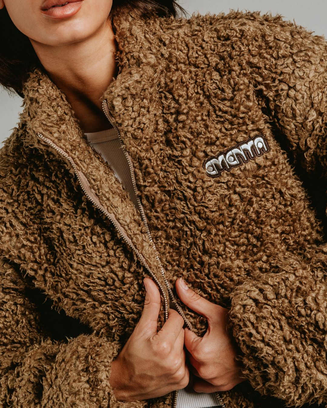 The Poncha Jacket in camel is designed for warmth and comfort with its soft camel fur exterior. Inside, it features diamond stitching for added texture and durability.
It offers elasticated wrists and hips for a customizable fit, two exterior pockets and an interior pocket for convenient storage.