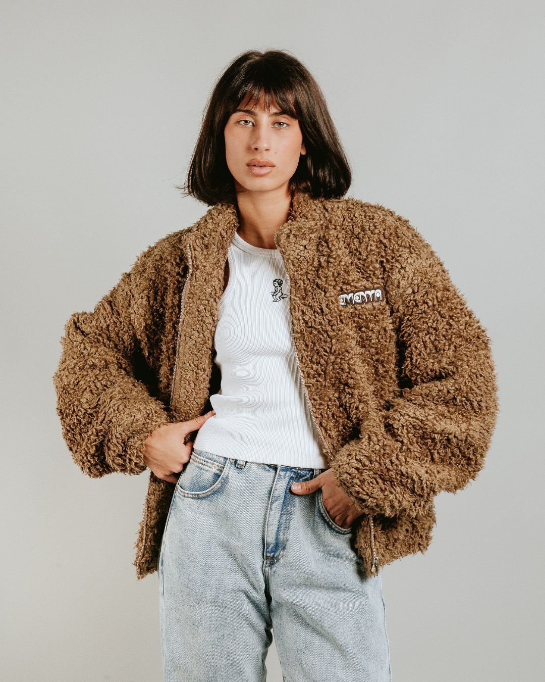 The Poncha Jacket in camel is designed for warmth and comfort with its soft camel fur exterior. Inside, it features diamond stitching for added texture and durability.
It offers elasticated wrists and hips for a customizable fit, two exterior pockets and an interior pocket for convenient storage.