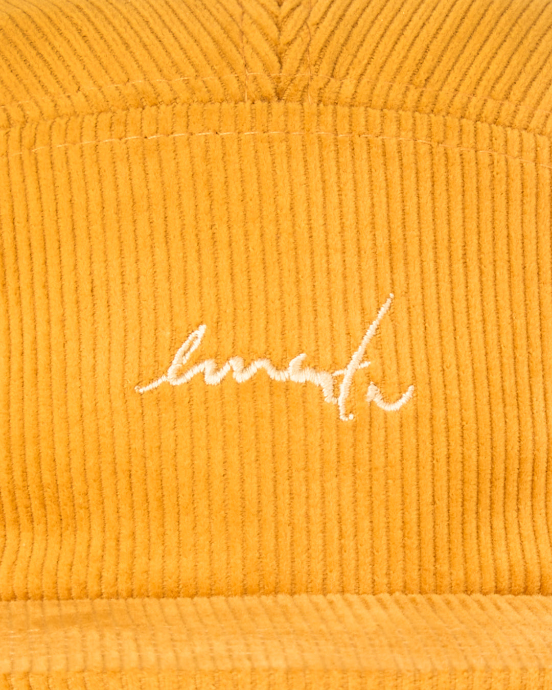 A five-panel cap made from cotton corduroy, offering a structured feel with a firm, flat brim. It features our signature embroidery on the front, adding a distinct touch. The adjustable strap with a plastic buckle ensures a secure and comfortable fit.