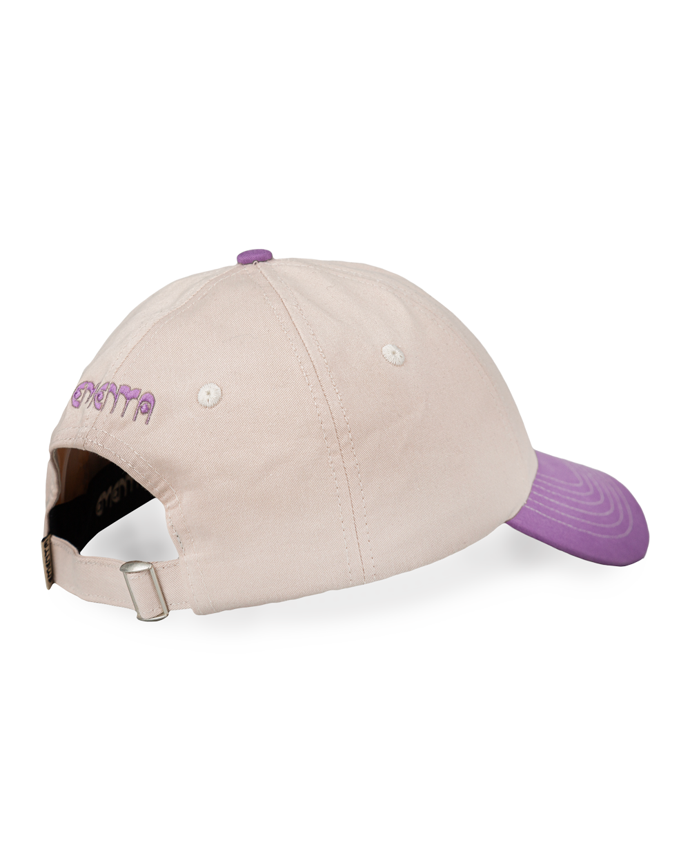 Off-white crown, purple brim, white stitching holding it all together. The Ikon Flower is embroidered on the front, the kind of detail that makes you look twice. On the side, "Moved by Friendship" is stitched in, a reminder of what really matters. Around back, the Dots logo sits above the adjustable strap—small details that tie it all together.