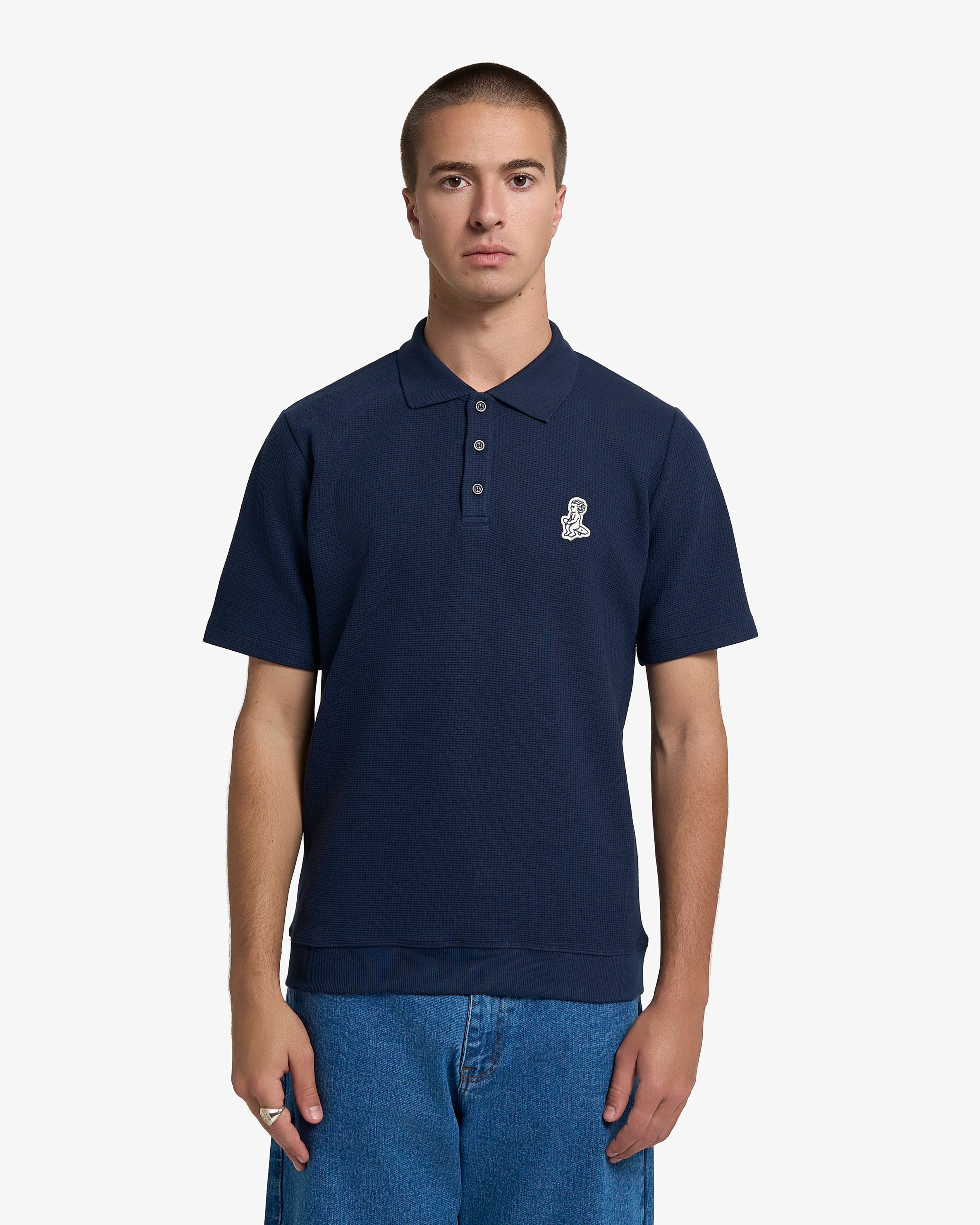 Ementa Polo Shirt
Waffle knit texture for enhanced breathability and structure
Ikon logo patch on the chest
Button-up front with four tonal buttons
Ribbed collar and sleeves
100% cotton
Regular fit
Unisex
Made in Portugal