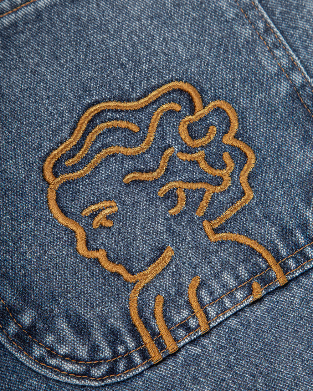 The Big Ikon Jeans Relaxed Fit Pants are designed with a baggy, relaxed straight fit and a mid-waist, offering comfort and ease of movement. The pants are crafted from blue fade-out denim, providing a timeless and durable look. They feature the Ikon logo embroidered in gold on the back pocket. The pants also include two front pockets, two back pockets, and one side pocket for practical storage.
