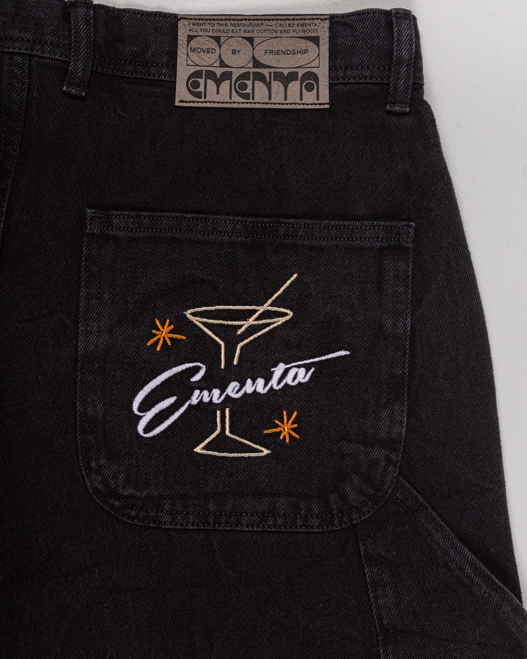 Relaxed-fit jeans made from black marble-washed denim, designed for comfort and durability with a focus on providing the perfect fit. The jeans feature the cocktail design embroidered on the back pocket for added detail. Equipped with two back pockets, two front pockets, and one side pocket for practical storage.