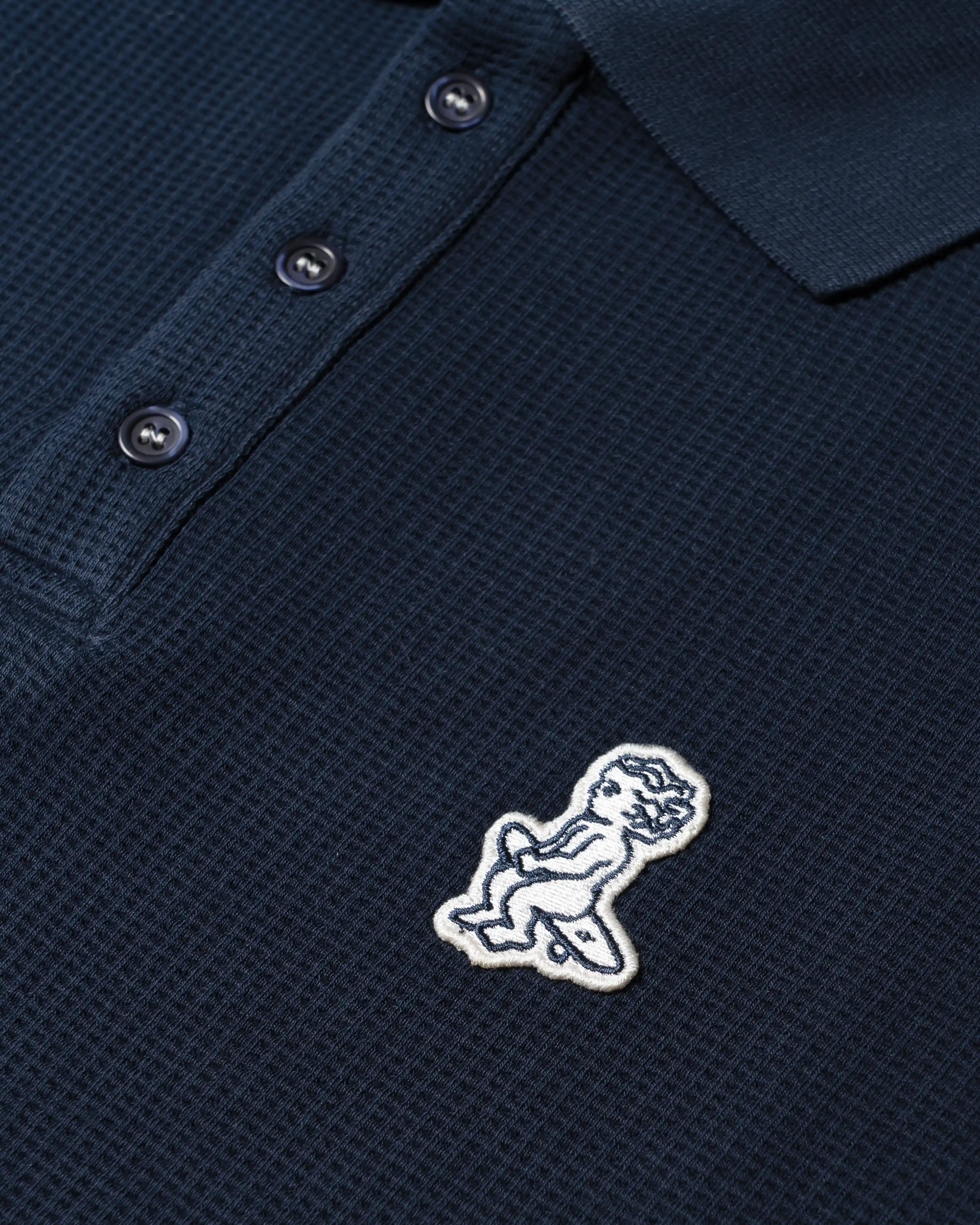 Ementa Polo Shirt
Waffle knit texture for enhanced breathability and structure
Embroidered Ikon logo on the chest
Button-up front with four tonal buttons
Ribbed collar and sleeves
100% cotton
Regular fit
Unisex
Made in Portugal