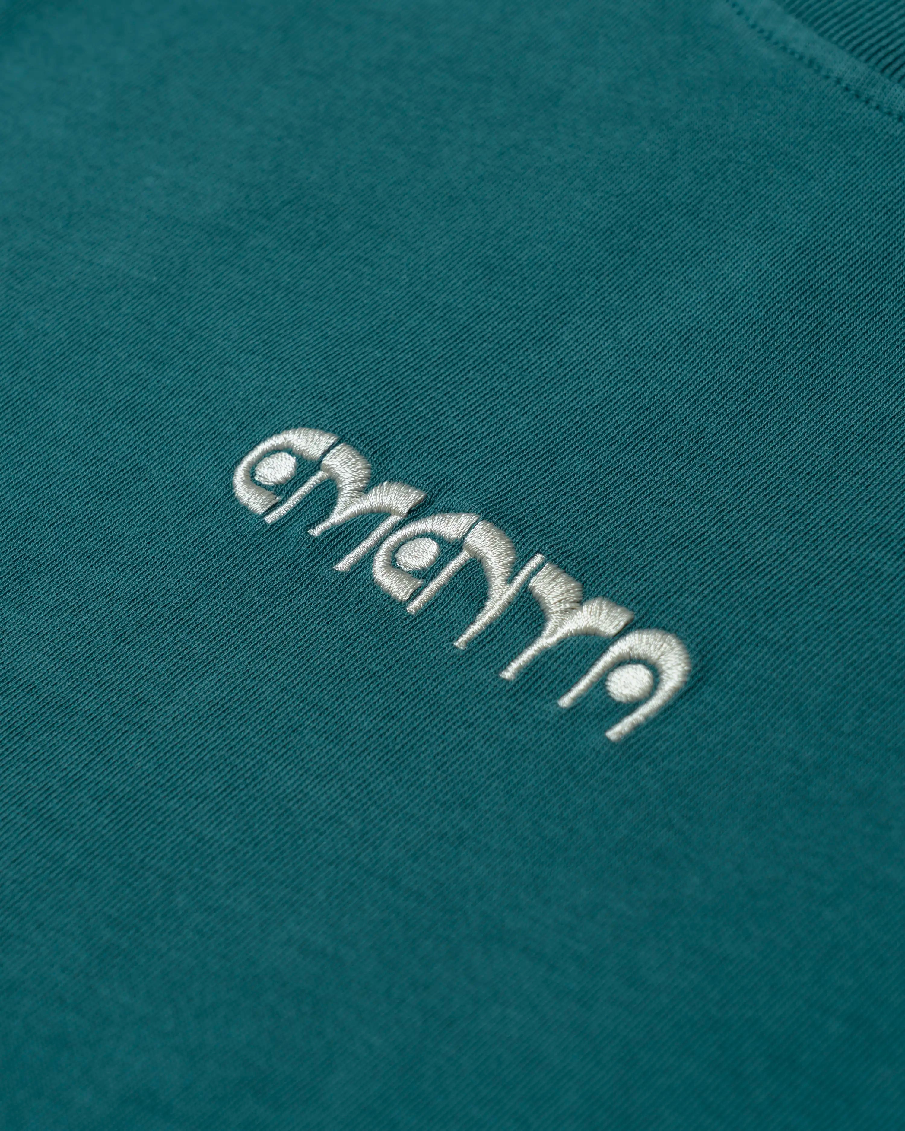 100% cotton, 240 g/m²
Soft feel with a slightly structured shape
Petrol color with off-white "First Word" print
Pre-shrunk to hold its shape after washing
Reinforced collar and double-stitched hems for durability
Unisex fit
Made in Portugal