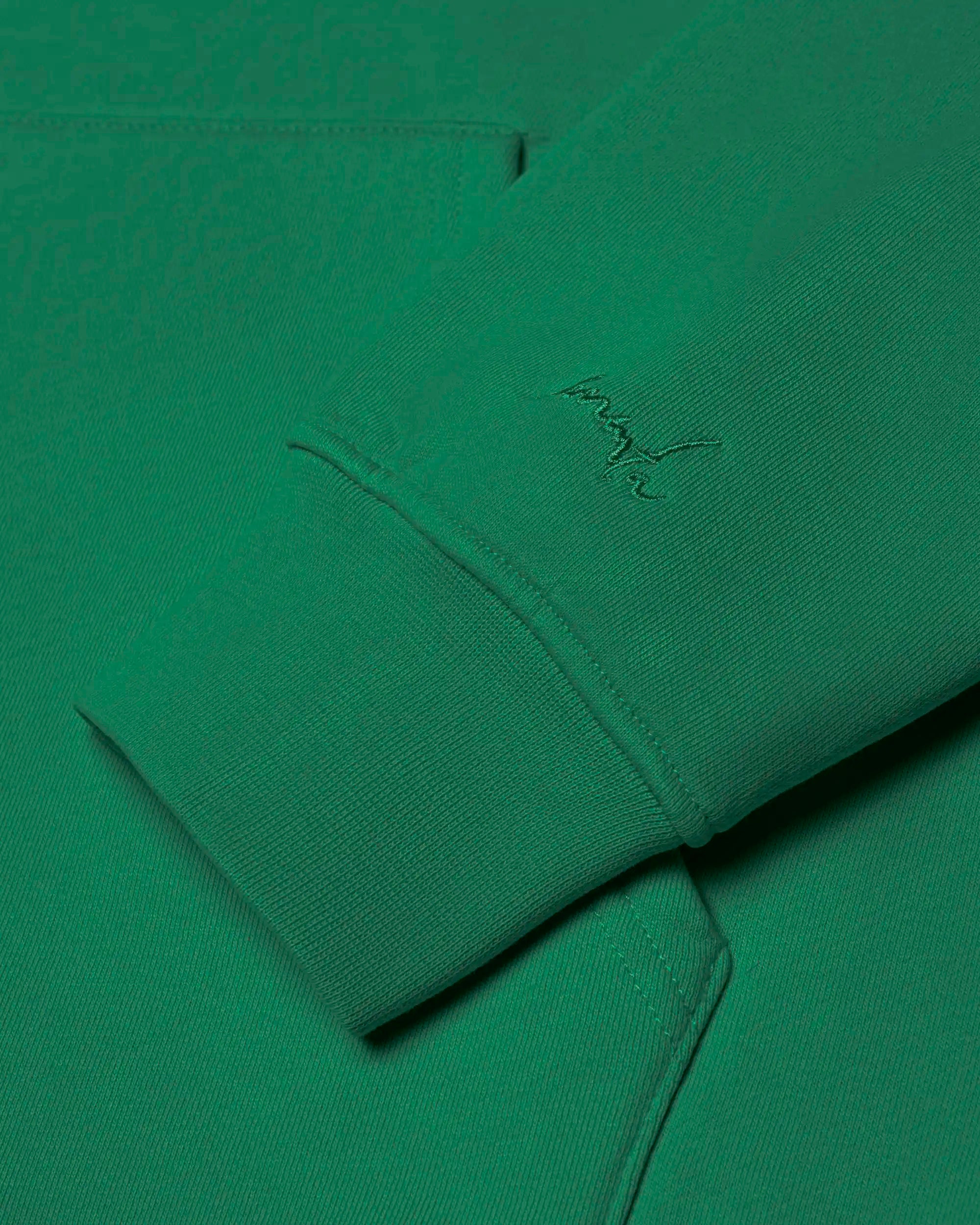 100% cotton (480 gsm) with brushed fleece interior
Evergreen color with an embossed textured Ikon stamp on the back
Subtle signature embroidery on the right wrist
Ribbed cuffs and hem for secure, comfortable fit
Classic kangaroo pocket for easy storage
Zip-less design with a clean pullover silhouette
Made in Portugal
Unisex fit