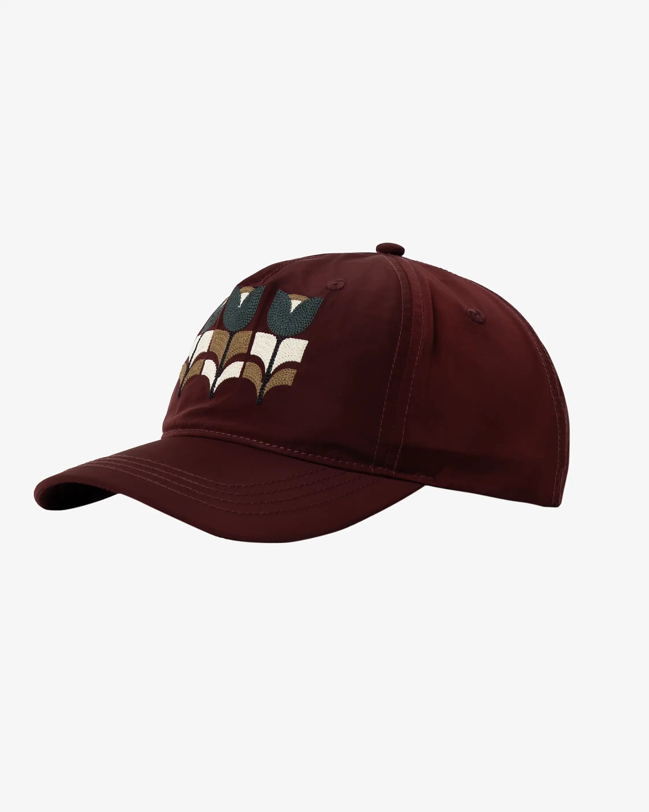 Six-panel cap designed for everyday wear.
Lightweight nylon fabric with a smooth finish and quick-drying feel.
Features a triple tulip embroidery inspired by the Flourish artwork on the front, with "Moved By Friendship" embroidery on the back.
Curved brim with an adjustable fabric strap and metal buckle for a customizable fit.
Burgundy finish with tonal stitching and multicolour embroidery details.
Made in Portugal.