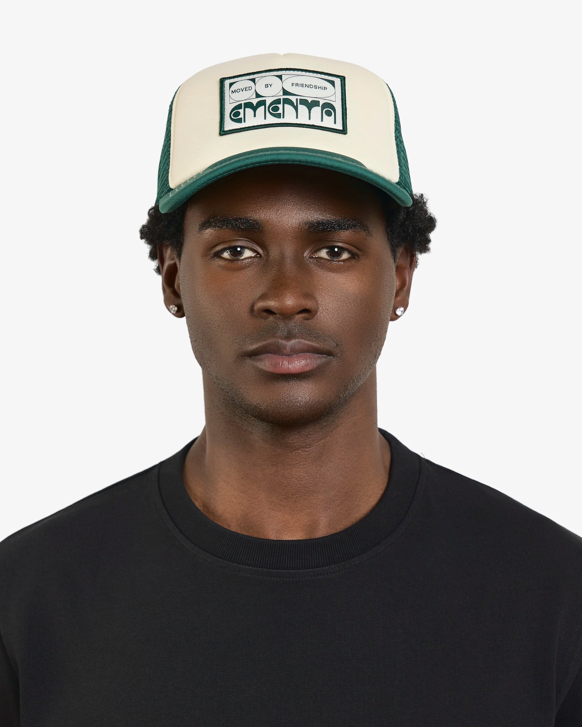 Lightweight and breathable trucker cap designed for everyday wear
Off-white cotton twill front panel with green breathable mesh for ventilation
Curved green brim with visible white stitching for subtle contrast
‘Moved By Friendship’ patch on the front, reflecting the spirit of connection and community
Adjustable back strap for a customizable and comfortable fit
Made in Portugal