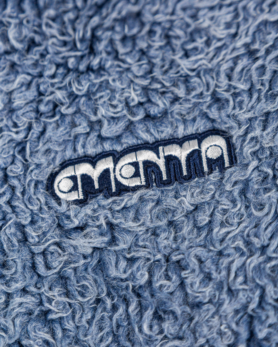 The Poncha Jacket is designed for warmth and comfort with its soft blue fur exterior. Inside, it features diamond stitching for added texture and durability.

It offers adjustable wrists and hips for a customizable fit, along with two exterior pockets and an interior pocket for convenient storage.