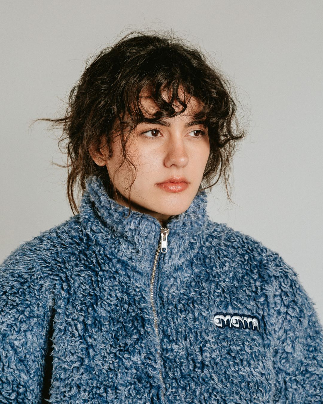 The Poncha Jacket is designed for warmth and comfort with its soft blue fur exterior. Inside, it features diamond stitching for added texture and durability.

It offers elasticated wrists and hips for a customizable fit, two exterior pockets and an interior pocket for convenient storage.