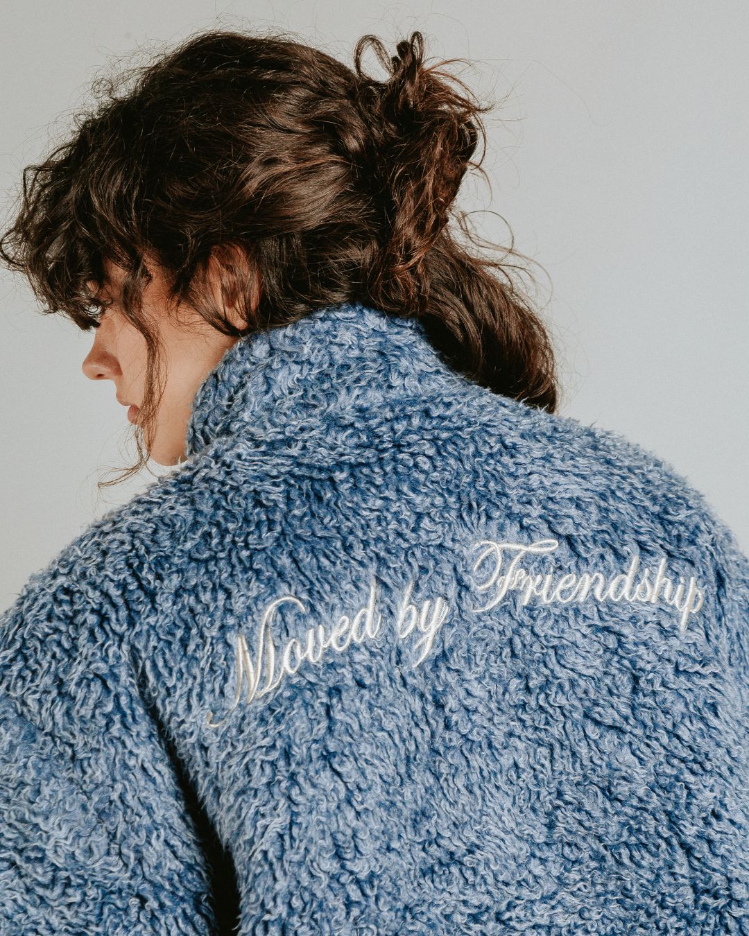 The Poncha Jacket is designed for warmth and comfort with its soft blue fur exterior. Inside, it features diamond stitching for added texture and durability.

It offers elasticated wrists and hips for a customizable fit, two exterior pockets and an interior pocket for convenient storage.