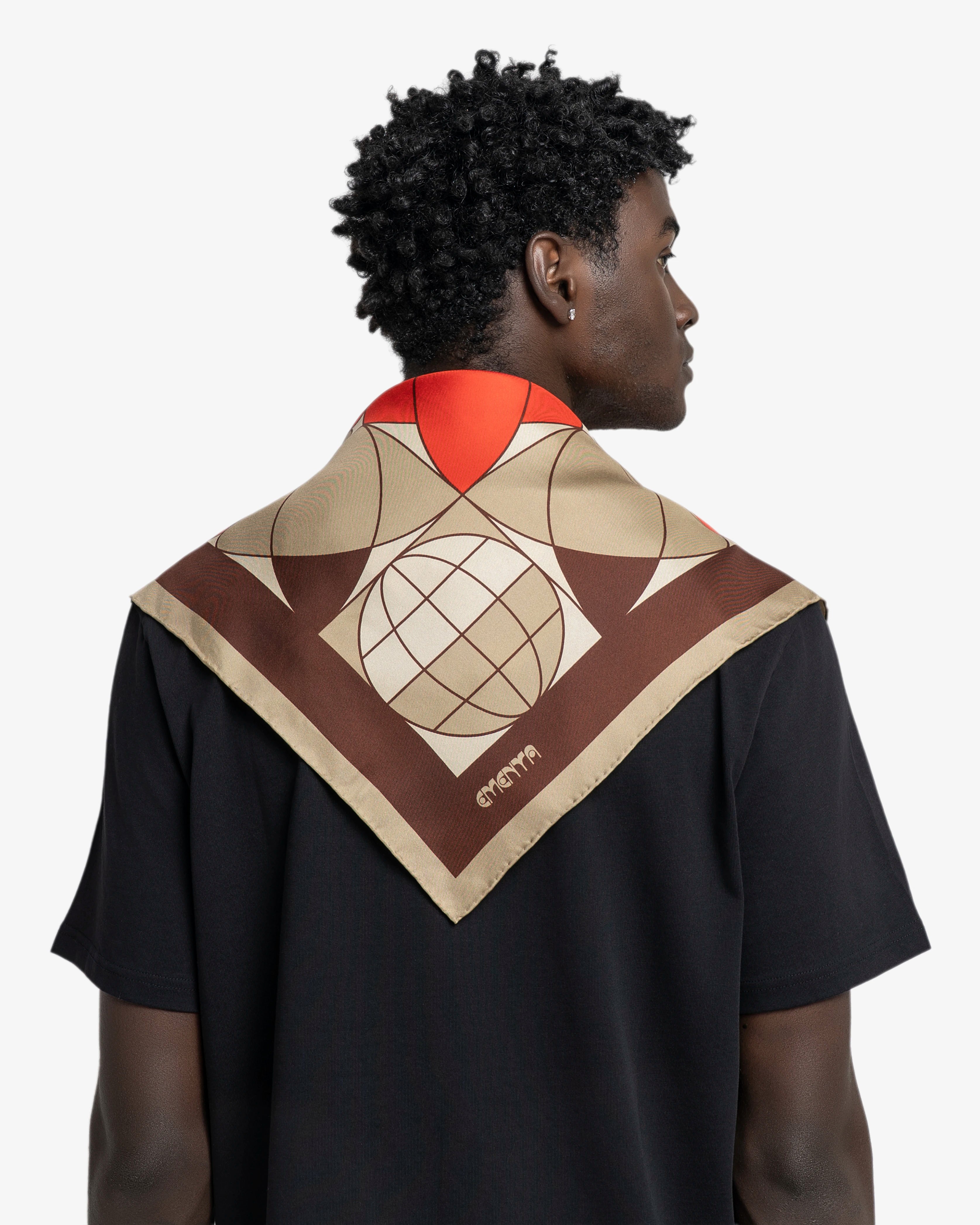 Silk scarf designed as a versatile accessory for styling around the neck, head or bag
Lightweight silk with a smooth, fluid hand feel
90 × 90 cm square shape featuring a geometric floral pattern in red, coral, beige and dark brown
Blossom artwork combines repeated petal forms with globe-inspired graphic elements and fine line detailing
Finished with a dark brown border framing the central pattern
