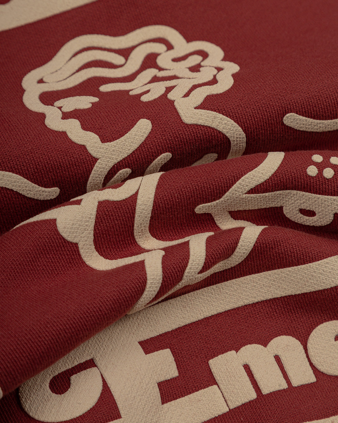 This burgundy hoodie is made of heavyweight fabric, designed to hold its shape and resist frequent wear. It is designed to ensure durability and warmth. Our artists digitally designed the print.