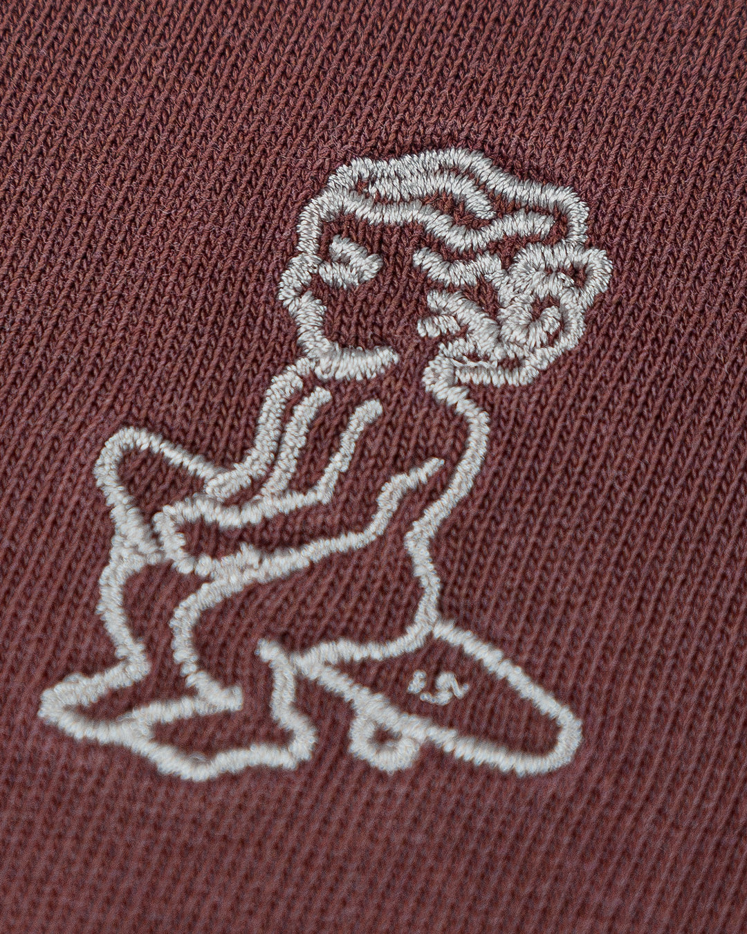 The Ikon Washed T-Shirt has a burgundy-washed finish and features the Ikon stamp embroidery on both the front and back, crafted from 100% cotton for lasting comfort and durability.