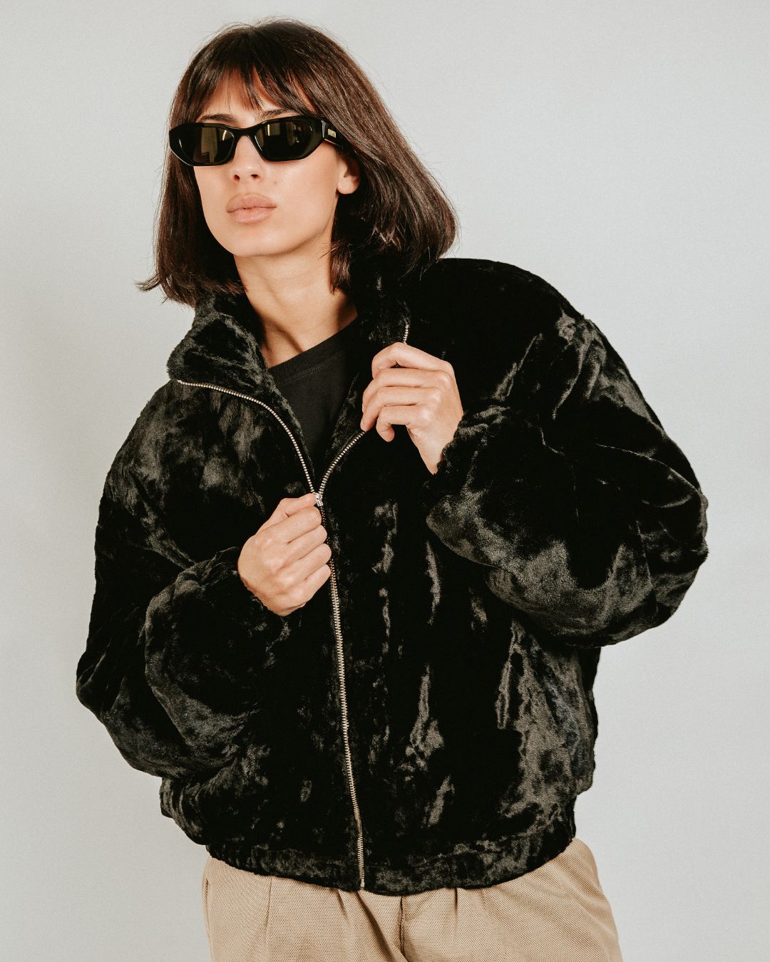 The Milaya Black Fur Jacket is designed for warmth and comfort, featuring a soft black fur exterior. Inside, it has diamond stitching for added texture and durability.

The jacket includes adjustable elasticated wrists and hips for a customizable fit, along with two exterior pockets and one interior pocket for storage.