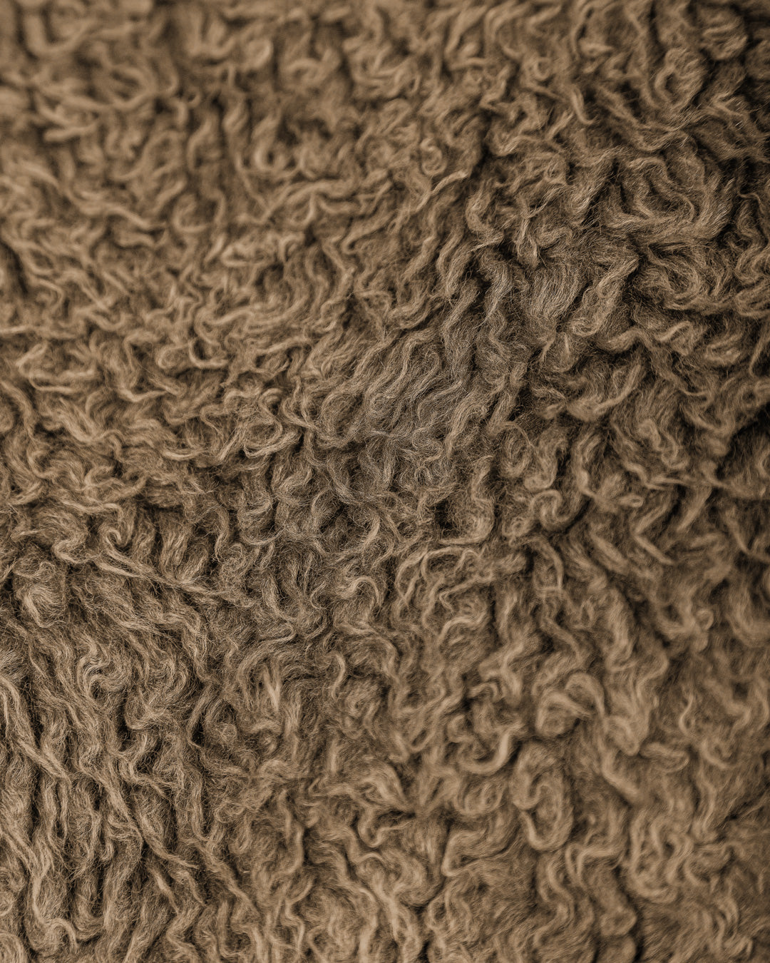 The Poncha Jacket in camel is designed for warmth and comfort with its soft camel fur exterior. Inside, it features diamond stitching for added texture and durability.

It offers elasticated wrists and hips for a customizable fit, two exterior pockets and an interior pocket for convenient storage.
