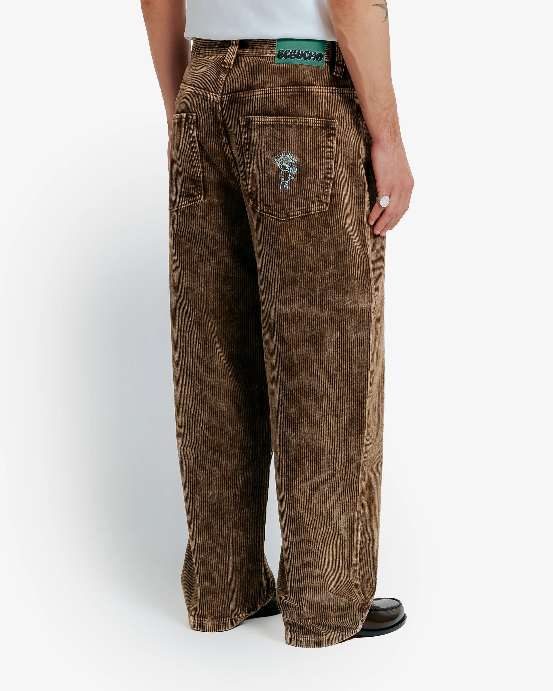 Artist Edition
Bonga is our baggy fit. It is very loose from waist to ankle, designed for comfort and a bold, laid-back look.

100% cotton corduroy for a soft, textured feel

Classic five-pocket design with belt loops
Button closure with full button fly for secure fastening

Embroidered front pocket butterfly detail&nbsp;
Bebucho design embroidered on the back pocket
Reinforced stitching ensures durability

Wide wale corduroy with bold ridges for extra texture

Unisex fit designed to suit all genders