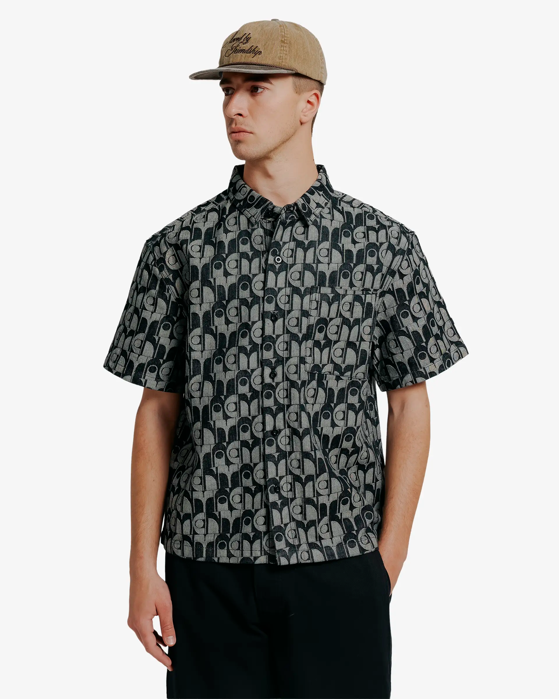 Short sleeve shirt designed for everyday wear
Midweight woven fabric with a structured feel and textured surface
Relaxed fit with a straight silhouette
All-over geometric dots pattern woven throughout the fabric
Button closure with chest pocket and tonal black buttons
Black and grey contrast pattern across front and back panels
Made in Portugal
