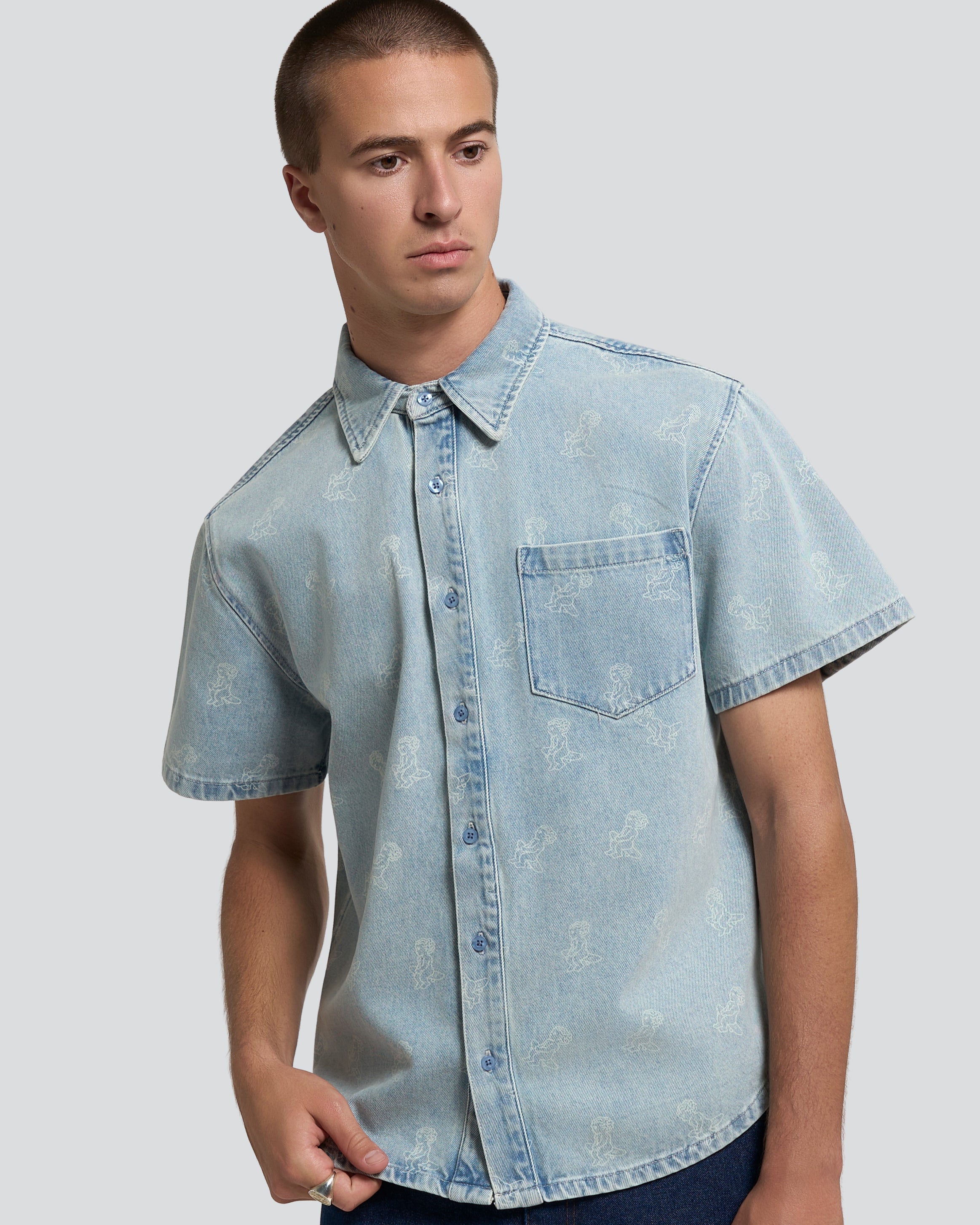 Light blue denim with all-over Ikon logo
Pair with the matching Emodi Kit Shorts for a complete look
Made from 100% cotton for a soft, breathable feel
Short-sleeved construction with a single chest pocket
Button front closure with tonal stitching
Slightly dropped shoulders for a relaxed silhouette
Unisex design&nbsp;
Cold wash only